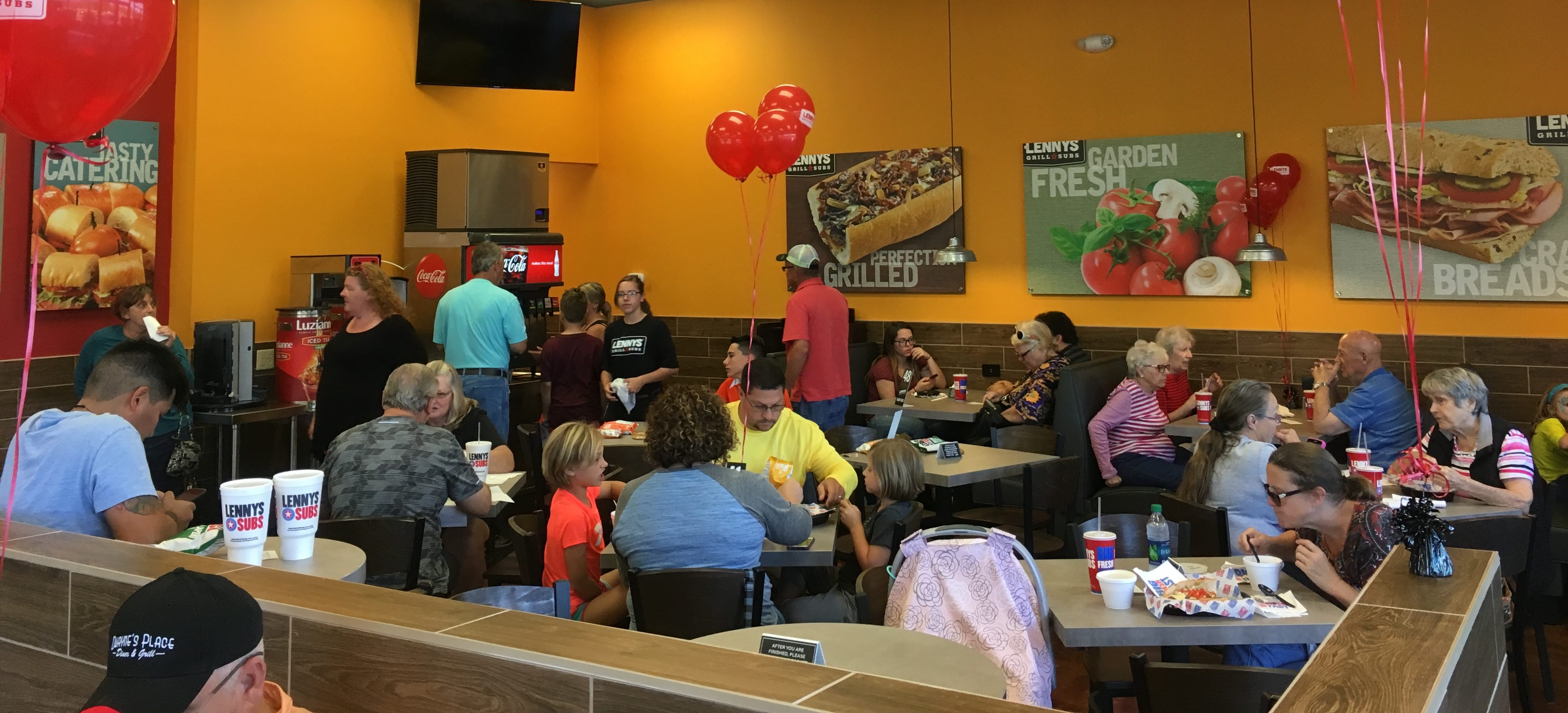 Guests eating in a Lennys Grand Opening