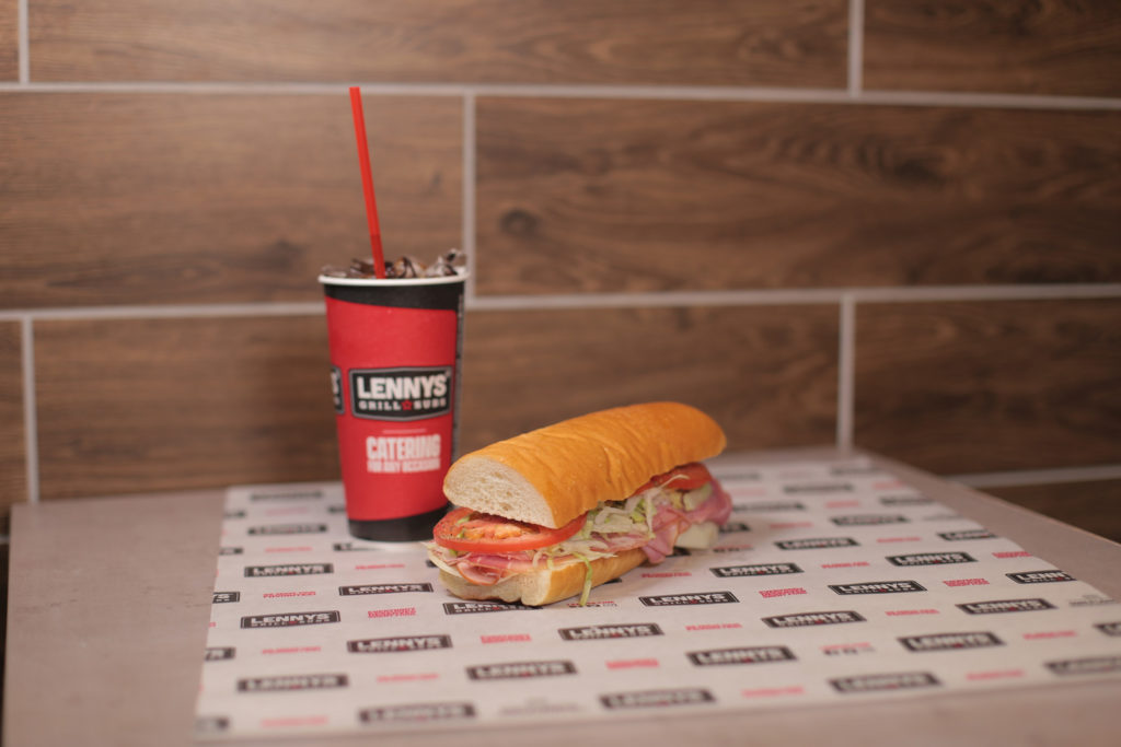 Lennys sub franchise, a sandwich and drink on table